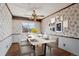 Charming dining room with floral wallpaper and a modern table at 16994 E Bethany Pl, Aurora, CO 80013