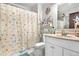 Cozy bathroom with a vanity and shower with a fun, themed shower curtain at 4620 Blackhawk Way, Denver, CO 80239