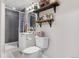 Modern bathroom with tiled shower, modern vanity, and open shelving for storage at 4620 Blackhawk Way, Denver, CO 80239