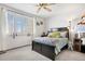 Sun-filled bedroom with a ceiling fan, shutters, and plush carpeting at 4620 Blackhawk Way, Denver, CO 80239