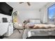 Bright bedroom with a cozy swing chair, plush bedding, and lots of natural light at 4620 Blackhawk Way, Denver, CO 80239