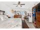 Cozy bedroom with ceiling fan, vanity area, dresser, and bright natural light at 4620 Blackhawk Way, Denver, CO 80239