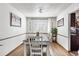Bright dining room with wood floors, plantation shutters, and access to kitchen at 4620 Blackhawk Way, Denver, CO 80239