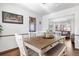 Open dining room with a dining table, bench seating and connection to the living room at 4620 Blackhawk Way, Denver, CO 80239