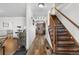 Inviting entryway with wood floors, staircase, and a glimpse of the kitchen at 4620 Blackhawk Way, Denver, CO 80239