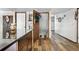 Functional hallway with storage, wood flooring, and convenient access to other rooms at 4620 Blackhawk Way, Denver, CO 80239