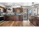Beautiful kitchen featuring stainless steel appliances, dark cabinets, and a pass-through window at 4620 Blackhawk Way, Denver, CO 80239