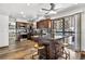 Bright kitchen features stainless steel appliances, center island with stools, and backyard access at 4620 Blackhawk Way, Denver, CO 80239