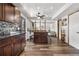 Open kitchen featuring an island with seating, wood floors, and modern fixtures at 4620 Blackhawk Way, Denver, CO 80239