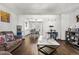 Comfortable living area with hardwood floors, a cat tree and easy access to the dining room at 4620 Blackhawk Way, Denver, CO 80239