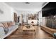 Inviting living room with fireplace, view of kitchen, and hardwood flooring at 4620 Blackhawk Way, Denver, CO 80239