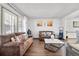 Inviting living room with hardwood floors, bright windows, and comfortable seating at 4620 Blackhawk Way, Denver, CO 80239