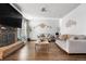 Spacious living room boasts hardwood floors, brick fireplace, and neutral decor at 4620 Blackhawk Way, Denver, CO 80239