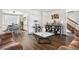 Spacious open-concept living area featuring hardwood floors, a cozy cat tree, and staircase access at 4620 Blackhawk Way, Denver, CO 80239