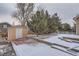 Backyard featuring a stone patio, shed, landscaping and privacy fence at 5300 Morning Glory Pl, Highlands Ranch, CO 80130