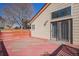 Side view of back deck that features painted wood and sliding glass doors to enter the residence at 19962 E Kent Dr, Aurora, CO 80013