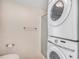 Bathroom with stackable washer and dryer, combined with walk-in shower and toilet at 19962 E Kent Dr, Aurora, CO 80013