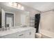 Bathroom featuring a dual sink vanity with marble countertop and a shower with a curtain at 19962 E Kent Dr, Aurora, CO 80013