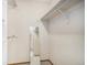 Walk-in closet with carpeting, a mirror, and hanging rods with shelving above for storage at 19962 E Kent Dr, Aurora, CO 80013