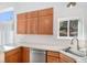Kitchen features light countertops, stainless steel appliances, and an abundance of wooden cabinetry at 19962 E Kent Dr, Aurora, CO 80013