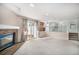 Open concept living room with cozy brick fireplace, sliding door access to the outdoors, and staircase at 19962 E Kent Dr, Aurora, CO 80013