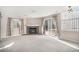Bright living room featuring a brick fireplace, large windows, and sliding door access to the patio at 19962 E Kent Dr, Aurora, CO 80013