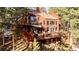 Multi-level home nestled in a wooded area with large deck at 29204 Wild Rose Dr, Evergreen, CO 80439