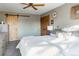 Bright bedroom with a queen-size bed and sliding barn door at 29204 Wild Rose Dr, Evergreen, CO 80439