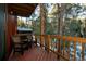 Wooden deck with chairs overlooking a wooded area at 29204 Wild Rose Dr, Evergreen, CO 80439