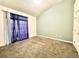 Bedroom with carpet, light green paint, and sliding glass door to the outside at 7440 S Blackhawk St # 208, Englewood, CO 80112