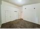 An empty bedroom offers neutral paint, three closets and carpeted floors at 7440 S Blackhawk St # 208, Englewood, CO 80112