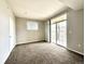 Spacious bedroom with carpet, a sliding glass door to the outside, and natural light at 7440 S Blackhawk St # 208, Englewood, CO 80112