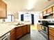 Features a functional kitchen with tiled countertops and modern stainless-steel appliances at 7440 S Blackhawk St # 208, Englewood, CO 80112