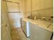 Laundry room with washer, dryer and wire shelving at 7440 S Blackhawk St # 208, Englewood, CO 80112
