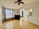 Bright living room featuring hardwood floors, a fireplace, and access to the kitchen at 7440 S Blackhawk St # 208, Englewood, CO 80112