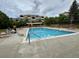 Community pool with lounge chairs and apartment building in the background at 7440 S Blackhawk St # 208, Englewood, CO 80112