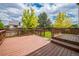 Relax on the expansive back deck with outdoor seating and lush greenery views at 2446 S Gibralter Way, Aurora, CO 80013