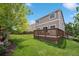 Enjoy the privacy of the backyard with a wooden deck and a lawn at 2446 S Gibralter Way, Aurora, CO 80013