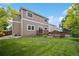 Spacious backyard with a well-maintained lawn and a wooden deck, great for entertaining at 2446 S Gibralter Way, Aurora, CO 80013