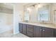 Elegant bathroom featuring double sinks, mirrors, modern fixtures, and a separate shower at 2446 S Gibralter Way, Aurora, CO 80013