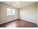 Cozy bedroom featuring hardwood floors, a ceiling fan, and a bright window at 2446 S Gibralter Way, Aurora, CO 80013