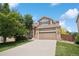 Charming two-story home featuring a two-car garage and well-maintained front yard at 2446 S Gibralter Way, Aurora, CO 80013