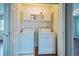 Convenient laundry room featuring a washer, dryer, storage cabinets, and a folding area at 2446 S Gibralter Way, Aurora, CO 80013