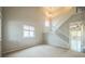 Well-lit room with high ceiling and staircase at 2446 S Gibralter Way, Aurora, CO 80013