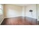 Open living room with sleek hardwood floors and a wall-mounted TV setup at 2446 S Gibralter Way, Aurora, CO 80013