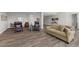 Finished basement with modern seating, wood-look floors, and ample living space at 11136 Sweet Cicely Dr, Parker, CO 80134