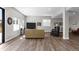 Open basement area with laminate floors, lots of lighting and comfortable furniture at 11136 Sweet Cicely Dr, Parker, CO 80134