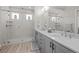 Modern bathroom with double vanity, large mirror, and glass-enclosed shower with bench at 11136 Sweet Cicely Dr, Parker, CO 80134