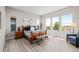 Bright bedroom with large windows, wood floors, and stylish furniture, creating a peaceful retreat at 11136 Sweet Cicely Dr, Parker, CO 80134