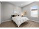 Comfortable bedroom with ample light, featuring wood floors and minimalist decor at 11136 Sweet Cicely Dr, Parker, CO 80134